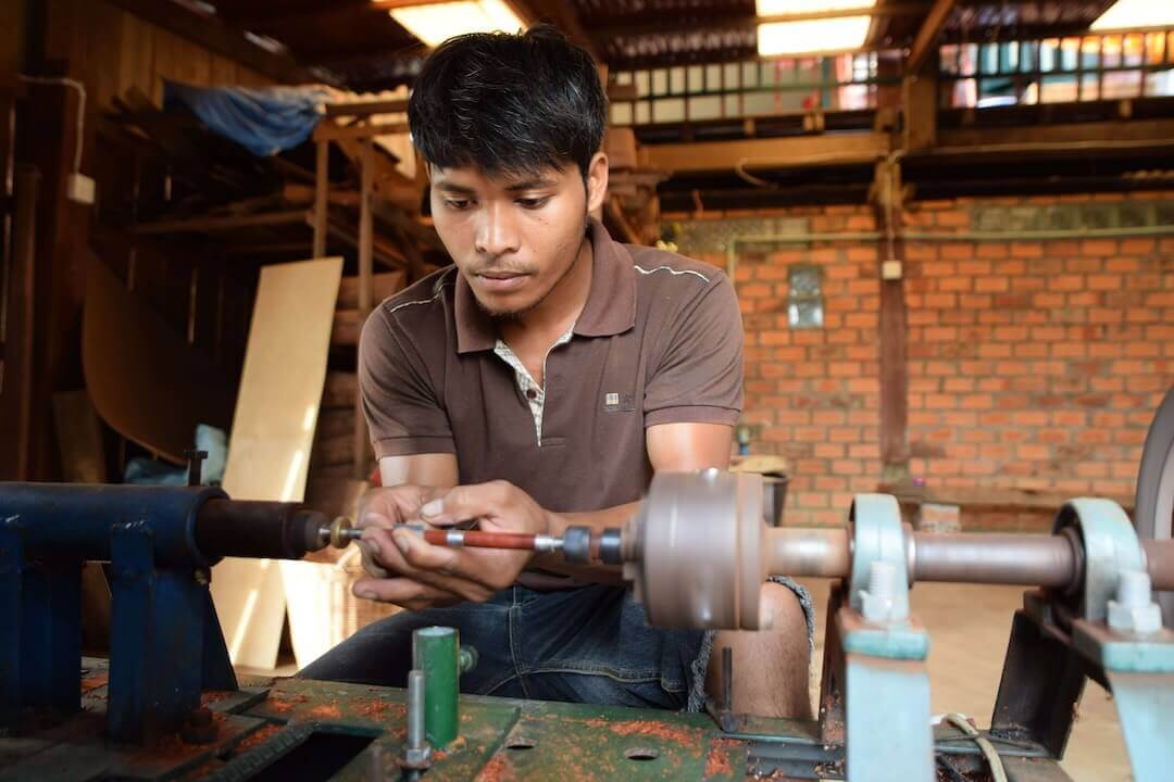 Timothee turning a pen on his lathe.