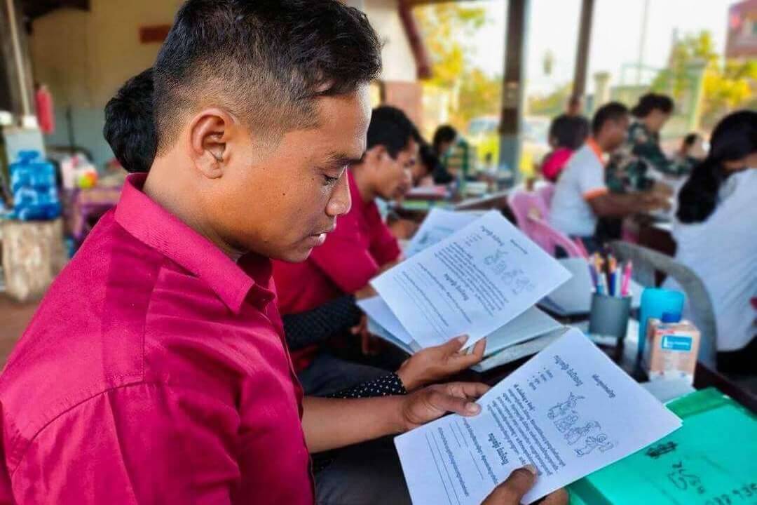 Preah Vihear School of Applied Ministry students reading handouts.