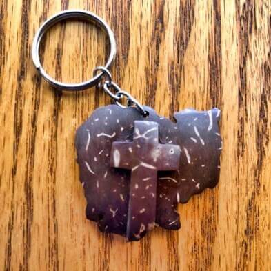 A cross keychain from coconut shells.