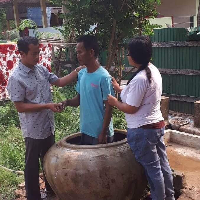 First adult believer in Bakam village being baptised.